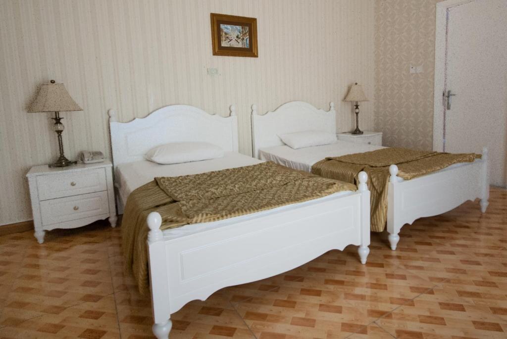 Twin beds with classic white furniture
